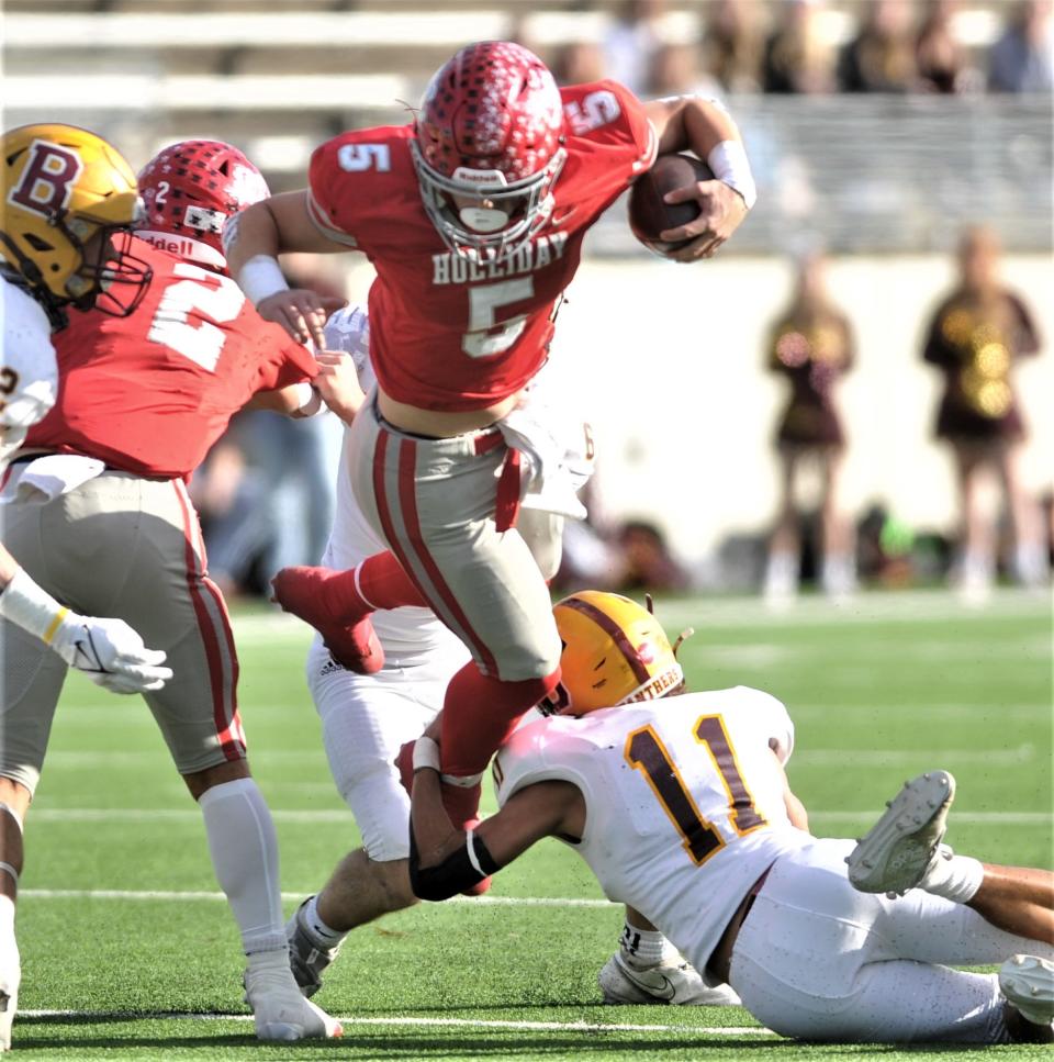 Holliday's Jaxx Johnson jumps over a Bells defender on Friday, November 26, 2021 in Denton.