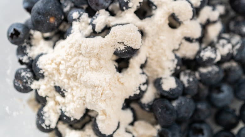 mixing blueberries with flour