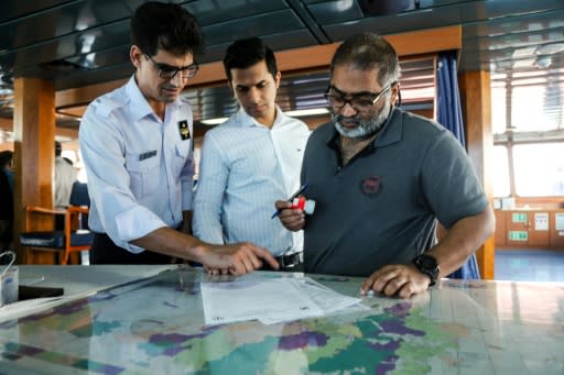 The captain (R) of the British-flagged oil tanker Stena Impero appears to be signing the ship's release documents before it leaves the port of Bandar Abbas port in southern Iran