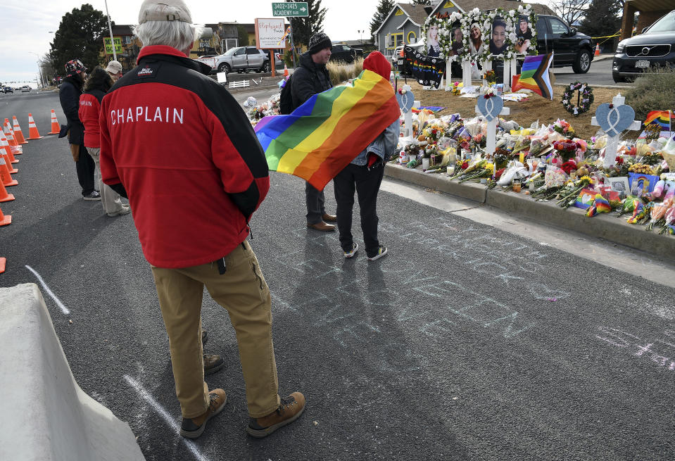 Jack Rasmusson, chaplain coordinator for the Billy Graham Rapid Response Team, works his way through the crowd at a memorial outside Club Q in Colorado Springs, Colo., on Wednesday, Nov. 23, 2022. Five people were killed when a gunman opened fire at the club Saturday night. (AP Photo/Thomas Peipert)