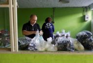 Luiz Carlos Fernandes, president of Coopama, a waste recycling cooperative, prepares donations to deliver to garbage collectors after they stopped working during the coronavirus disease (COVID-19) outbreak, in Rio de Janeiro