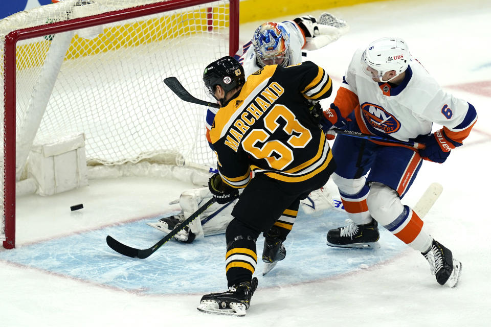 Boston Bruins center Brad Marchand (63) scores past New York Islanders goaltender Semyon Varlamov as Islanders defenseman Ryan Pulock (6) tries to defend in the second period of an NHL hockey game, Monday, May 10, 2021, in Boston. (AP Photo/Elise Amendola)