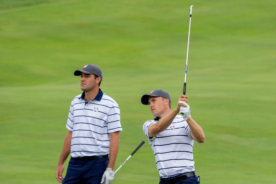 September 21, 2021; Kohler, Wisconsin, USA; U.S. Team player Jordan Spieth (right) hits his fairway shot in front of player Scottie Scheffler (left) on the ninth hole during a practice round for the 43rd Ryder Cup golf competition at Whistling Straits.