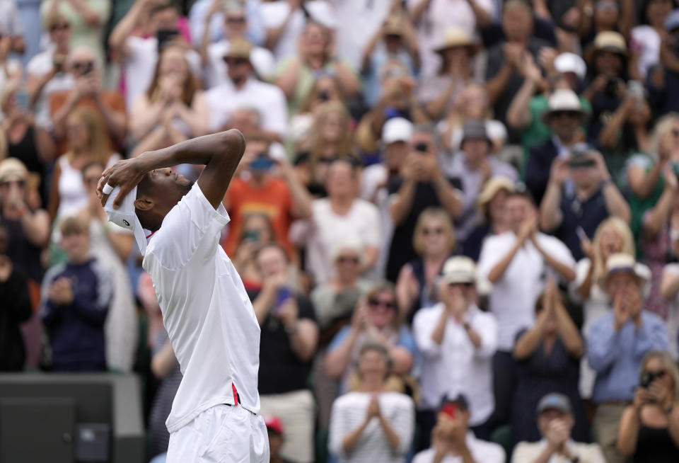 Christopher Eubanks of the US celebrates after beating Stefanos Tsitsipas of Greece in a men's singles match on day eight of the Wimbledon tennis championships in London, Monday, July 10, 2023. (AP Photo/Alastair Grant)