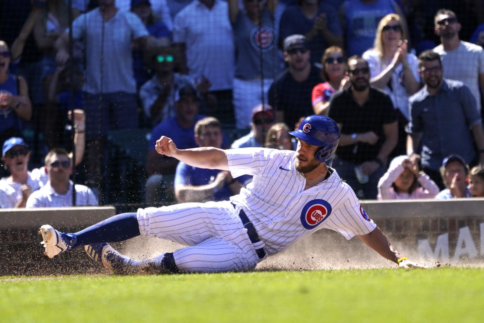 Chicago Cubs' Patrick Wisdom scores on Nick Madrigal's single during the seventh inning of a baseball game against the Washington Nationals Wednesday, Aug. 10, 2022, in Chicago. (AP Photo/Charles Rex Arbogast)