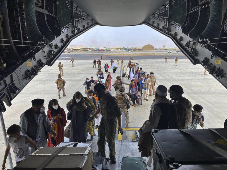 FILE - In this Wednesday, Aug. 18, 2021 file photo provided by the Spanish Defence Ministry and taken in Kabul, Afghanistan, people board a Spanish airforce A400 plane as part of an evacuation plan at Kabul airport in Afghanistan, Wednesday Aug. 18, 2021. (Spanish Defence Ministry via AP, File)