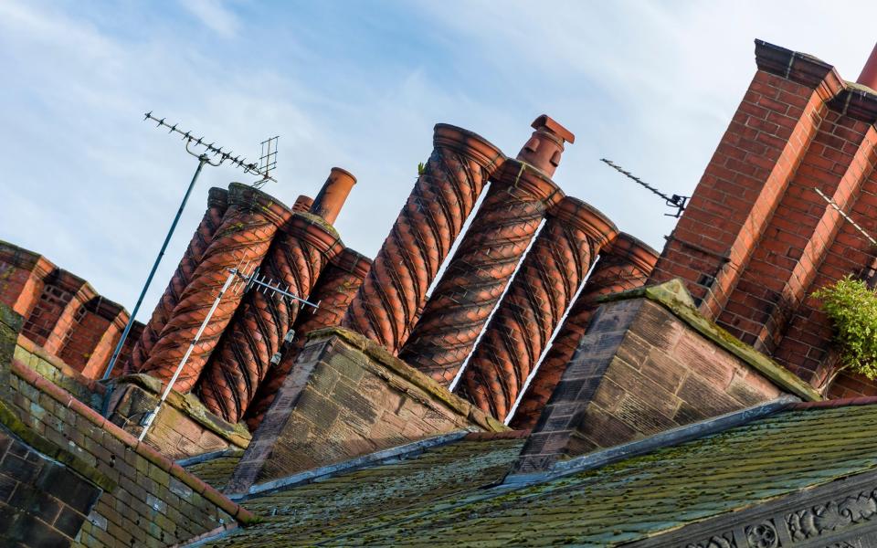 A row of elaborate Victorian chimneys on a terraced row in Port Sunlight