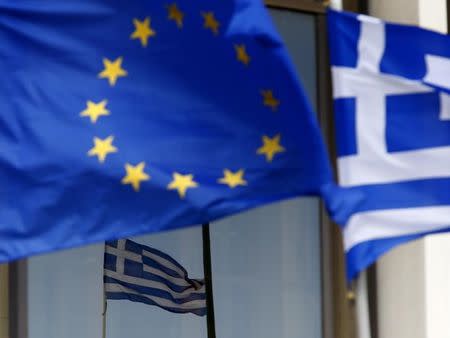 Greek and EU flags are seen outside the Foreign Ministry in Athens March 12, 2015. REUTERS/Yannis Behrakis