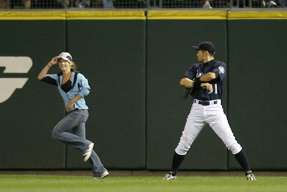 Right fielder Ichiro Suzuki #51 of the Seattle Mariners watches as a fan runs onto the field during the game against the New York Yankees on August 14, 2009 at Safeco Field in Seattle, Washington. (Photo by Otto Greule Jr/Getty Images)
