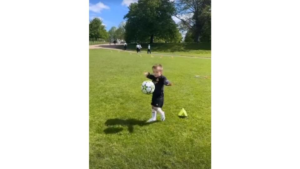 A young boy playing football