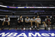 Chicago Bulls players sit on the side of the court before the start of a basketball practice at Mexico City Arena in Mexico City, Wednesday, Dec. 12, 2018. The Bulls will face Orlando Magic Thursday in the first of two 2018 regular-season NBA games to be played in the high-altitude Mexican capital. (AP Photo/Rebecca Blackwell)