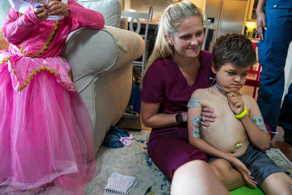 One of Braden's nurses, Carly Westcott, RN, helps prepare him for therapy. | Ilana Panich-Linsman for TIME