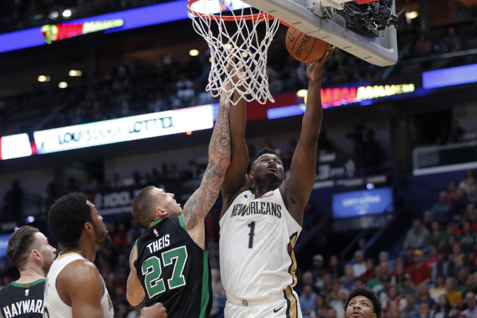 New Orleans Pelicans forward Zion Williamson (1) shoots against Boston Celtics center Daniel Theis (27) in the first half of an NBA basketball game in New Orleans, Sunday, Jan. 26, 2020. (AP Photo/Gerald Herbert)