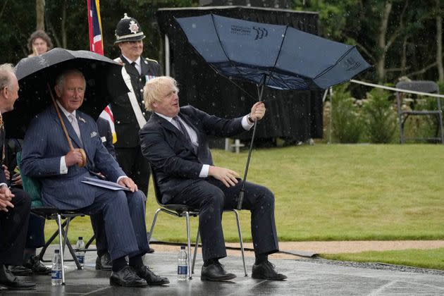 British Prime Minister Boris Johnson tries to open his umbrella next to Prince Charles at the dedication ceremony of the new national U.K. Police Memorial on July 28, 2021.  (Photo: CHRISTOPHER FURLONG via Getty Images)