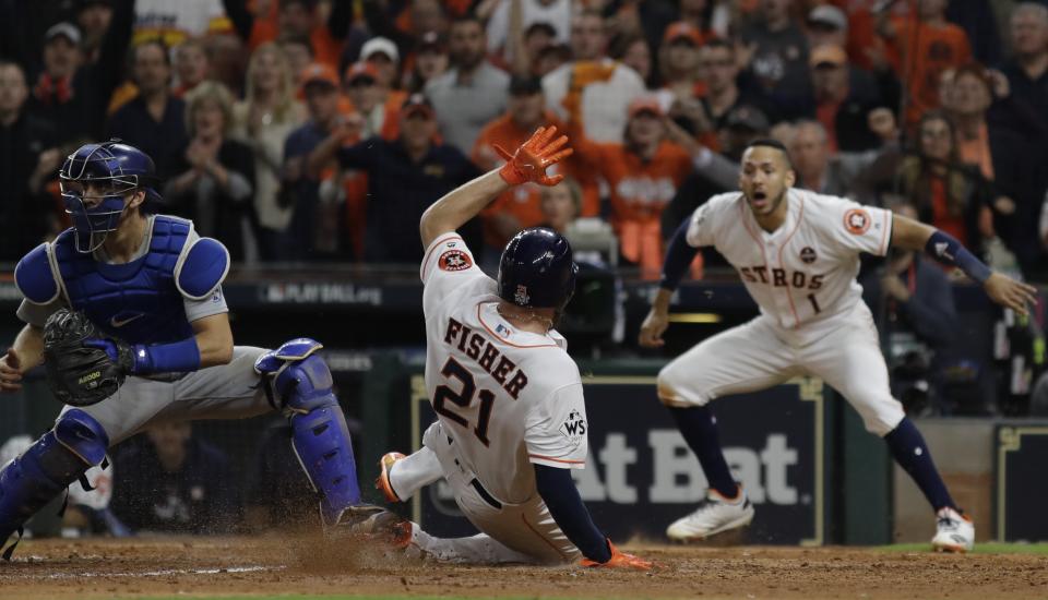 The Astros’ Derek Fisher scores on a hit by Alex Bregman during the 10th inning of Game 5. (AP)