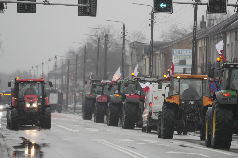 Protesting farmers in Poland are slow-driving their tractors on a road in Deblin, Poland, Wednesday, Jan. 24, 2024 to disturb traffic and draw attention to their disagreement to European Union regulations. Such protests were held across Poland. (AP Photo/Czarek Sokolowski)