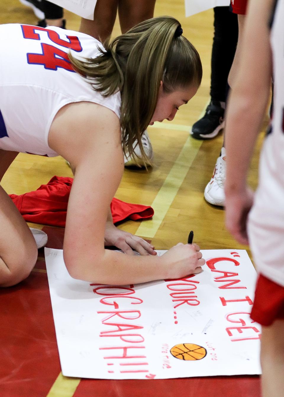 Bridgewater-Raynham's Jenna Micciantuono signs an autograph for young fans after a game against Dartmouth on Monday, Feb. 13, 2023.