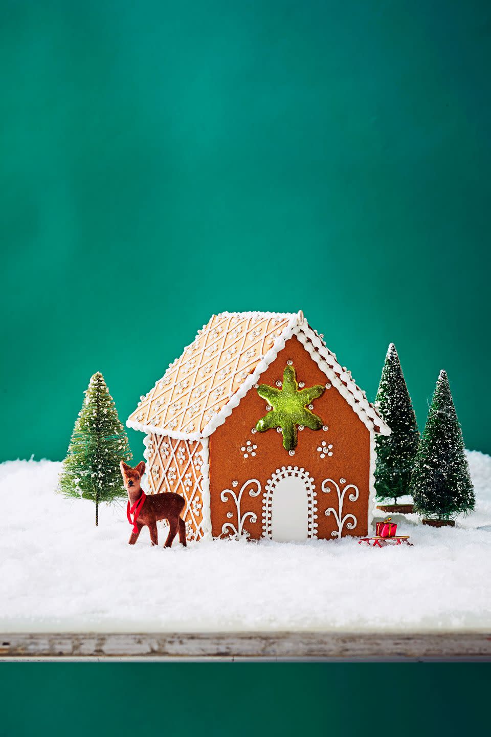 <p>Take a basic gingerbread house to the next level with an <a href="https://www.inthekitchenwithmatt.com/edible-sugar-glass" rel="nofollow noopener" target="_blank" data-ylk="slk:edible sugar glass star;elm:context_link;itc:0;sec:content-canvas" class="link ">edible sugar glass star</a> and intricately piped icing decorations.</p>