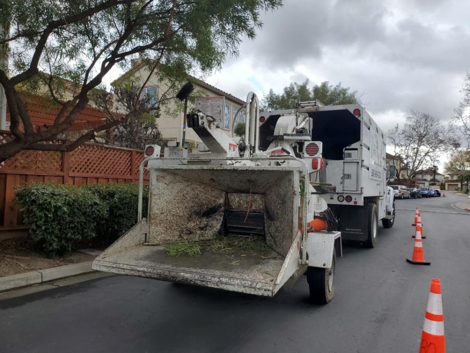 a wood chipper truck parked on a street