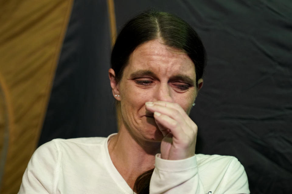 CORRECTS SPELLING TO CRISTIN, INSTEAD OF CRISTEN - Cristin Trahan cries inside a tent where she now lives with her husband, where their home once stood, in the aftermath of Hurricane Laura and Hurricane Delta, in Lake Charles, La., Friday, Dec. 4, 2020. (AP Photo/Gerald Herbert)