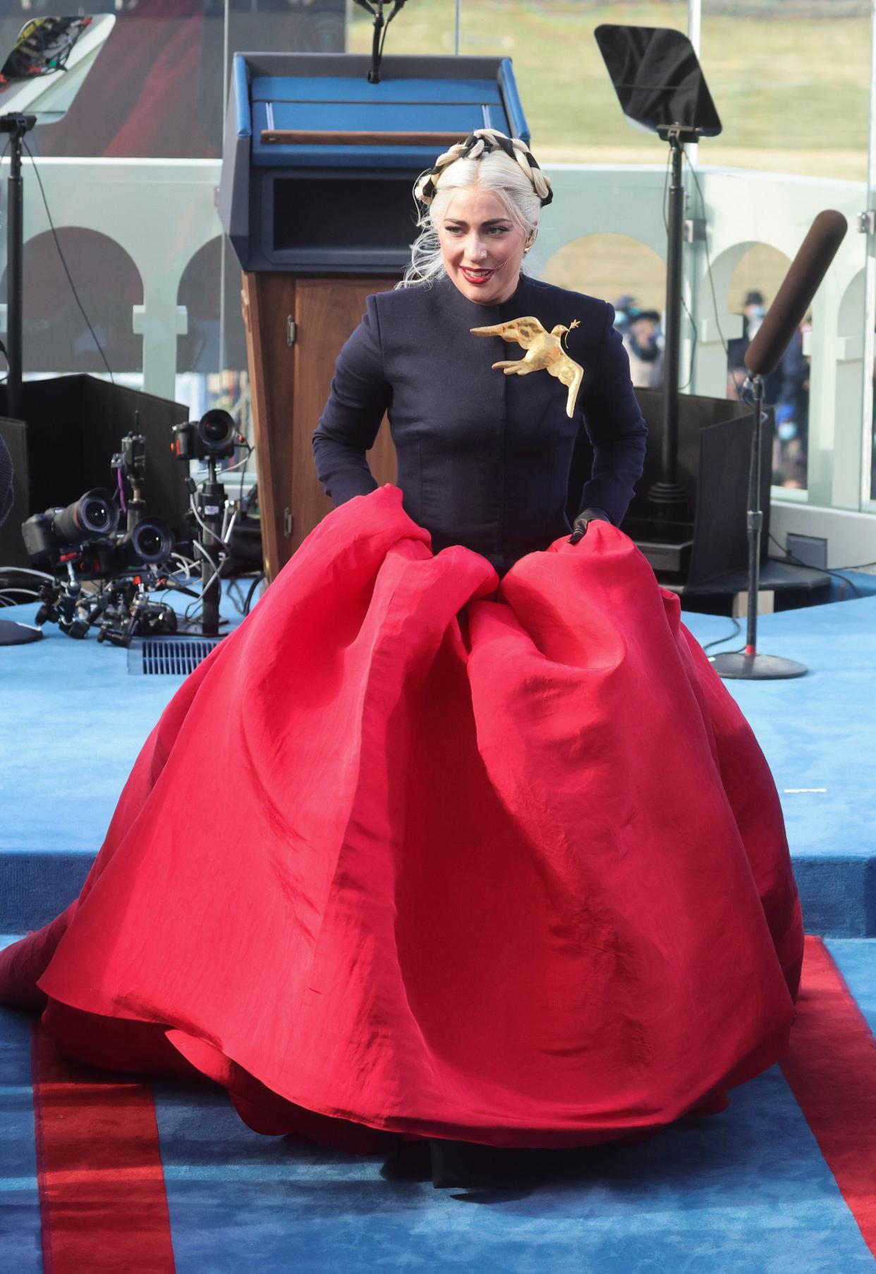 Lady Gaga picks up her skirt after singing the national anthem during the inauguration. (Photo: Pool via Getty Images)