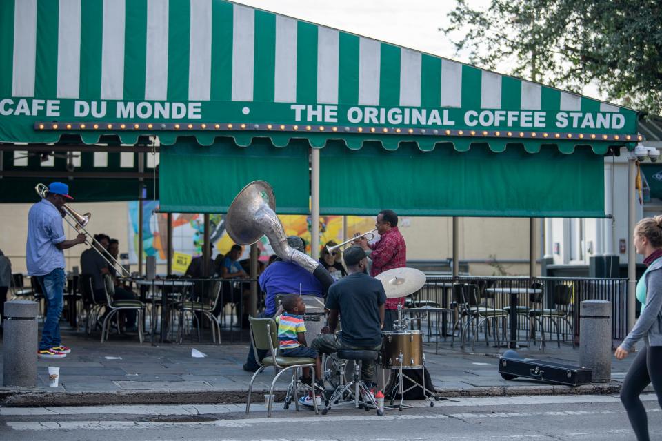 Jazz musicians play outside a nearly empty Cafe Du Monde in New Orleans'  French Quarter on Aug. 24 before Tropical Storm Marco was expected to hit the Gulf Coast.