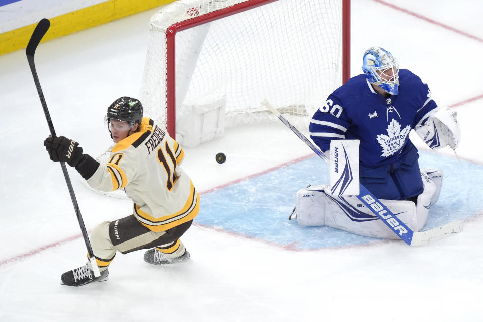 Boston Bruins center Trent Frederic (11) celebrates his goal against Toronto Maple Leafs goaltender Joseph Woll (60) during the second period of an NHL hockey game Thursday, March 7, 2024, in Boston. (AP Photo/Steven Senne)