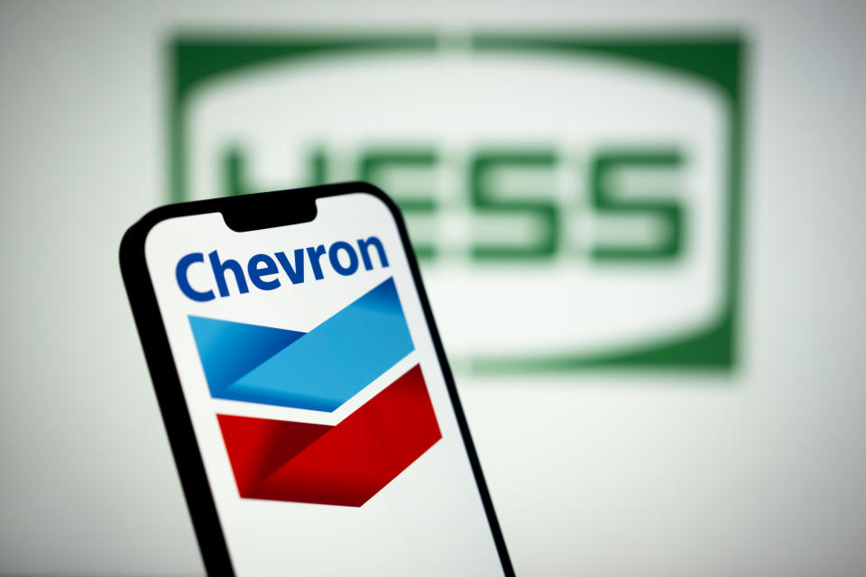 The Chevron logo is seen with the Hess logo in the background in this photo illustration on 13 March, 2023 in Warsaw, Poland. (Photo by Jaap Arriens/NurPhoto via Getty Images)