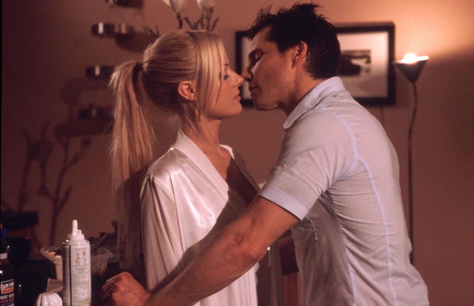 Madeleine West as Dee Bliss kissing Mark Raffety as Darcy Tyler in Neighbours (Fremantle Media/Shutterstock)