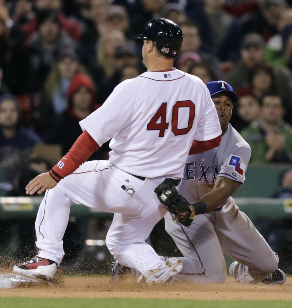 Texas Rangers third baseman Adrian Beltre can't make the tag in time as Boston Red Sox's A.J. Pierzynski (40) advances to third on a single by teammate Jackie Bradley Jr. during the second inning of a MLB baseball game at Fenway Park, Monday, April 7, 2014, in Boston.(AP Photo/Charles Krupa)