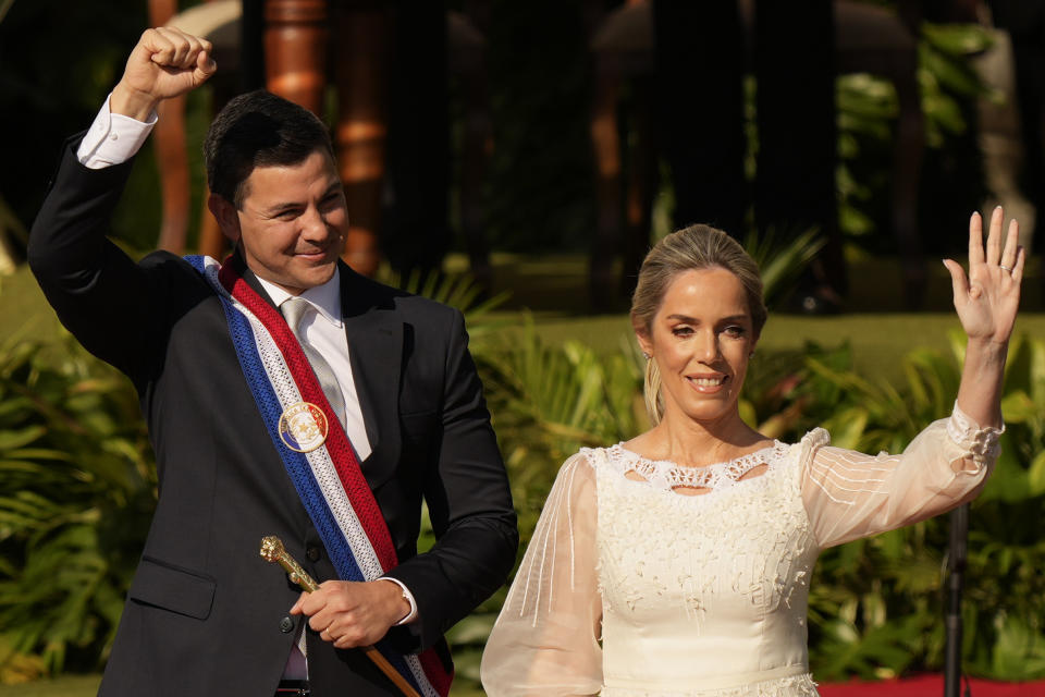 Paraguay's new President Santiago Pena and wife Leticia Ocampos wave after he was sworn-in on his inauguration day in Asuncion, Paraguay, Tuesday, Aug. 15, 2023. (AP Photo/Jorge Saenz)