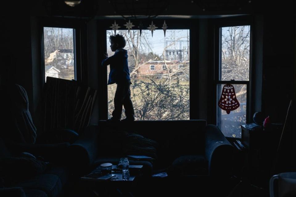 A child stands in the window of the Martin residence in the aftermath of a tornado on Dec. 10, 2023, in Madison, Tennessee.