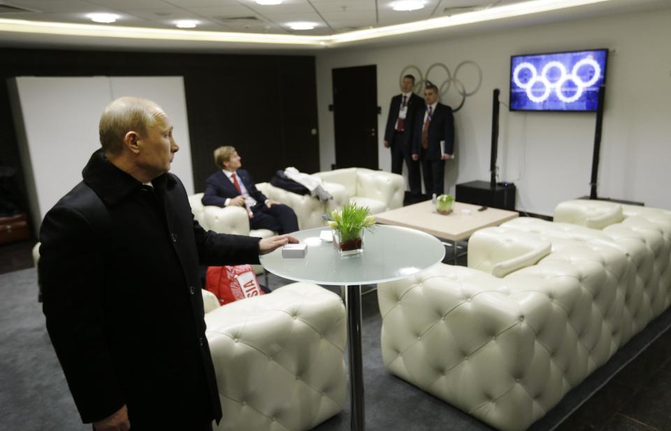 In this fourth in a sequence of four images, four seconds after the previous one, Russian President Vladimir Putin looks at a TV screen in the presidential lounge while he waits to be introduced at the opening ceremony of the 2014 Winter Olympics on Friday, Feb. 7, 2014, in Sochi, Russia. The image on the TV shows all five rings illuminated, and is footage from one of two rehearsals, held Feb. 1 and 4. It was inserted after one of the rings failed to open during the actual ceremony. (AP Photo/David Goldman, Pool)