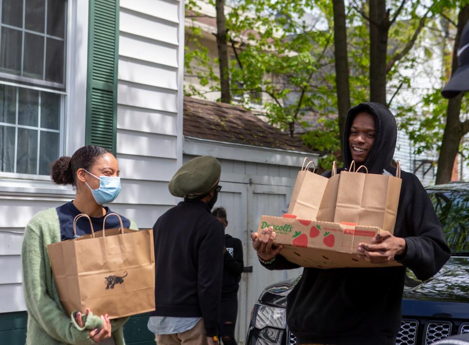 People’s Liberation Program members gather grocery bags together for their free grocery event in Rochester, N.Y. on May 7, 2022.