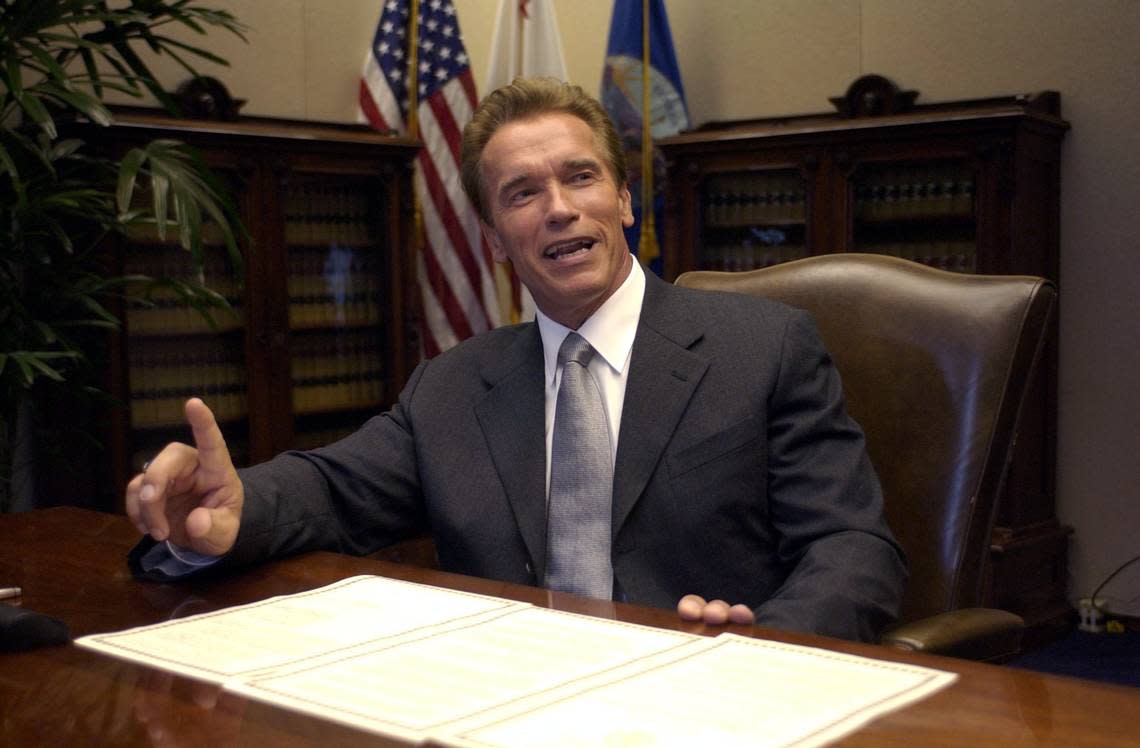 Gov. Arnold Schwarzenegger smiles before he signs an executive order to repeal the car tax minutes after taking the oath of office as California’s 38th governor on the steps of the state Capitol on Monday, Nov. 17, 2003. John Decker/Sacramento Bee file