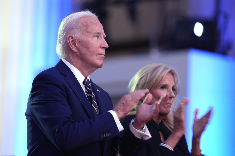 President Joe Biden, left, and first lady Jill Biden applaud before Biden delivers remarks on the 75th anniversary of NATO at the Andrew W. Mellon Auditorium, Tuesday, July 9, 2024, in Washington. (AP Photo/Evan Vucci)