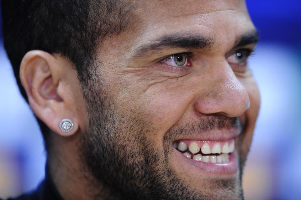 FC Barcelona's Daniel Alves, from Brazil, attends a press conference at the Sports Center FC Barcelona Joan Gamper in San Joan Despi, Spain, Monday, March 31, 2014. FC Barcelona will face Atletico Madrid in a first leg quarter-final Champions League soccer match on Tuesday. (AP Photo/Manu Fernandez)