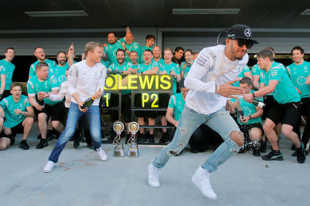 Formula One - Russian Grand Prix - Sochi, Russia - 1/5/16 - Mercedes F1 drivers Nico Rosberg of Germany and Lewis Hamilton of Britain celebrate their victory with the team. REUTERS/Maxim Shemetov