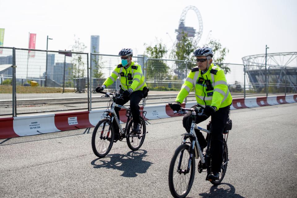 Police officers patrol in Queen Elizabeth Olympic Park in east London on April 24, 2020 during the national lockdown due to the novel coronavirus COVID-19 pandemic. (Photo by Tolga AKMEN / AFP) (Photo by TOLGA AKMEN/AFP via Getty Images)