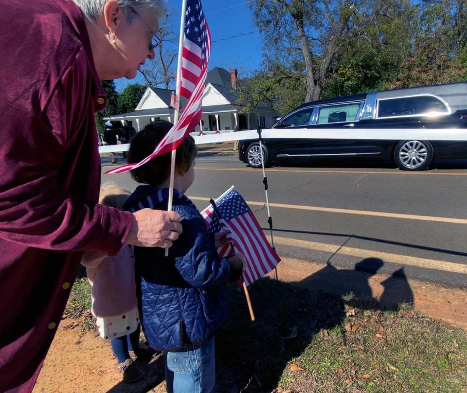 Spectators young and old lined the route to view t he funeral procession for Rosalynn Carter in Plains, Georgia on Wednesday afternoon. 11/29/2023 Mike Haskey/mhaskey@ledger-enquirer.com