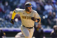 San Diego Padres' Victor Caratini heads up the first-base line after connecting for a grand slam off Colorado Rockies relief pitcher Robert Stephenson in the sixth inning of game one of a baseball doubleheader Wednesday, May 12, 2021, in Denver. (AP Photo/David Zalubowski)