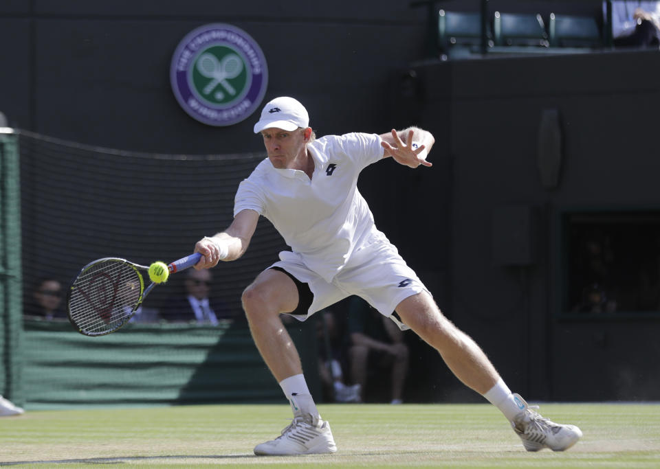 Kevin Anderson of South Africa returns the ball to Switzerland’s Roger Federer during their men’s quarterfinals match at the Wimbledon Tennis Championships, in London, Wednesday July 11, 2018. (AP Photo/Ben Curtis)