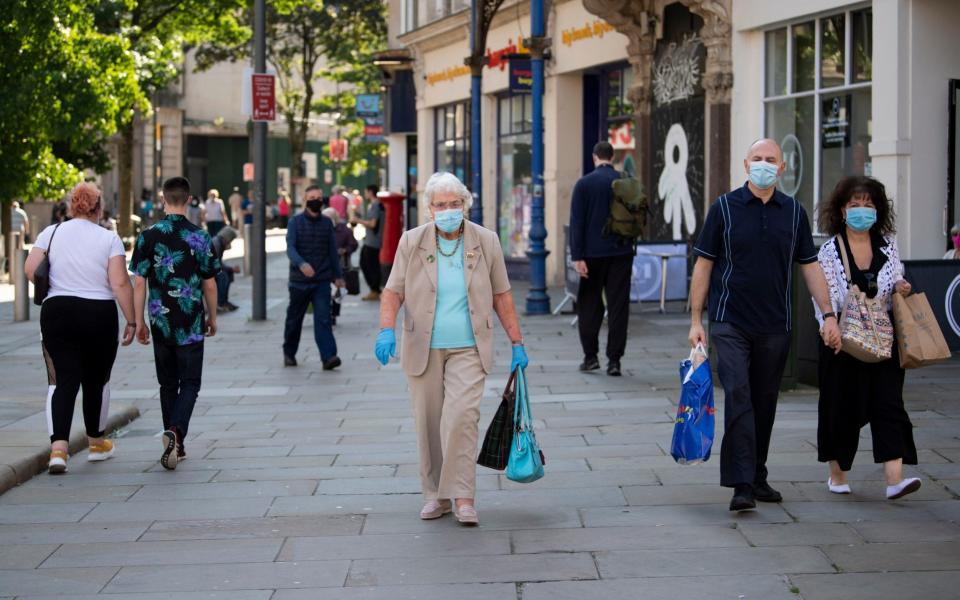 People wear face masks in Newport town centre  - Matthew Horwood/Getty Images