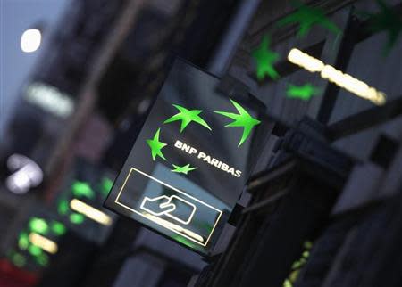 Illuminated signs light up at twilight outside the headquarters of the BNP Paribas bank in Paris January 30, 2012. REUTERS/Mal Langsdon