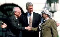 FILE PHOTO: File photo of U.S. President Clinton with Israeli Prime Minister Rabin and PLO President Yasser Arafat