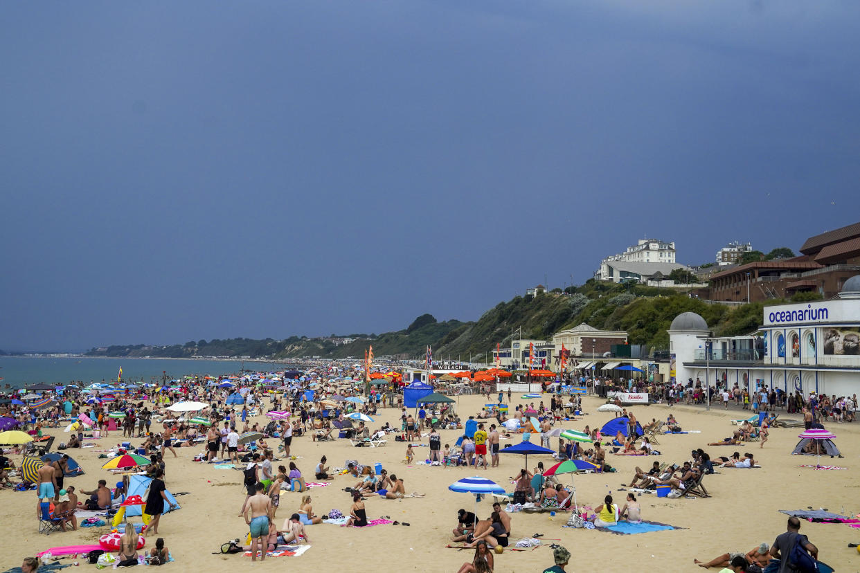 People on the beach in Bournemouth. Temperatures have reached 40C for the first time on record in the UK, with 40.2C provisionally recorded at London Heathrow, the Met Office has said. Picture date: Tuesday July 19, 2022.