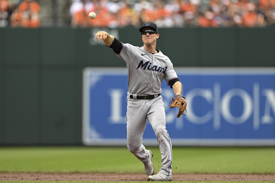 Miami Marlins shortstop Joey Wendle throws to first base for an out on a ball hit by Baltimore Orioles' Ramon Urias during the first inning of a baseball game, Sunday, July 16, 2023, in Baltimore. (AP Photo/Terrance Williams)