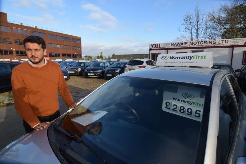 Ameen Sultani speaks as he shows some of the older, cheaper vehicles that have been popular with customers eager to avoid public transport during the coronavirus disease (COVID-19) pandemic, in Hayes