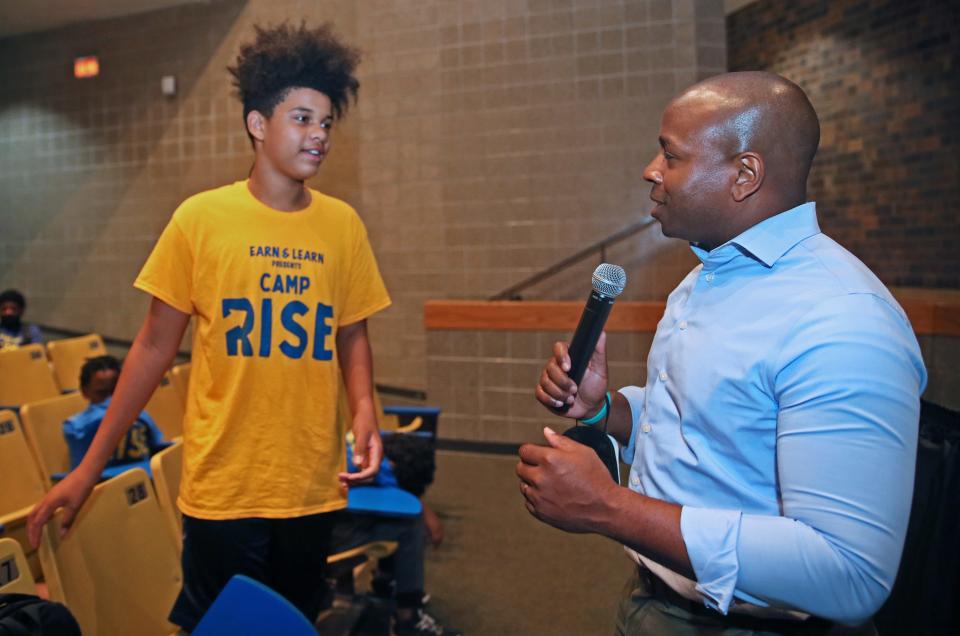 Elijah Adams, 13, left, asks Milwaukee Mayor Cavalier Johnson who he would vote for in the Senate race during the mayor's visit to Camp Rise, a summer youth program created this year for male teens between the ages of 10 and 15 at North Division High School. Participants will help beautify Milwaukee through community projects, build leadership and team-building skills, explore interests and careers, be mentored by camp leaders and more.