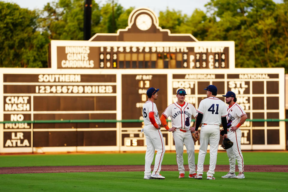 Giants infielders huddle during a pitching change. (Mary DeCicco/MLB Photos via Getty Images)